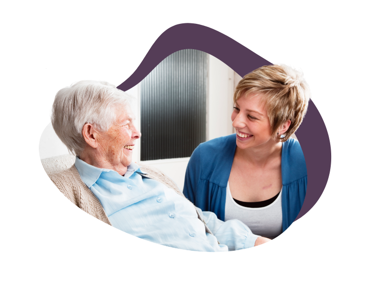 elderly woman smiling at another younger woman