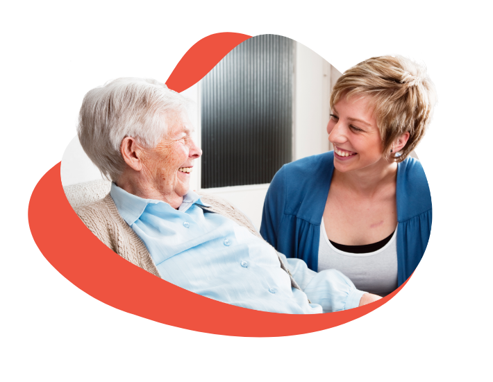 elderly woman smiling at another younger woman
